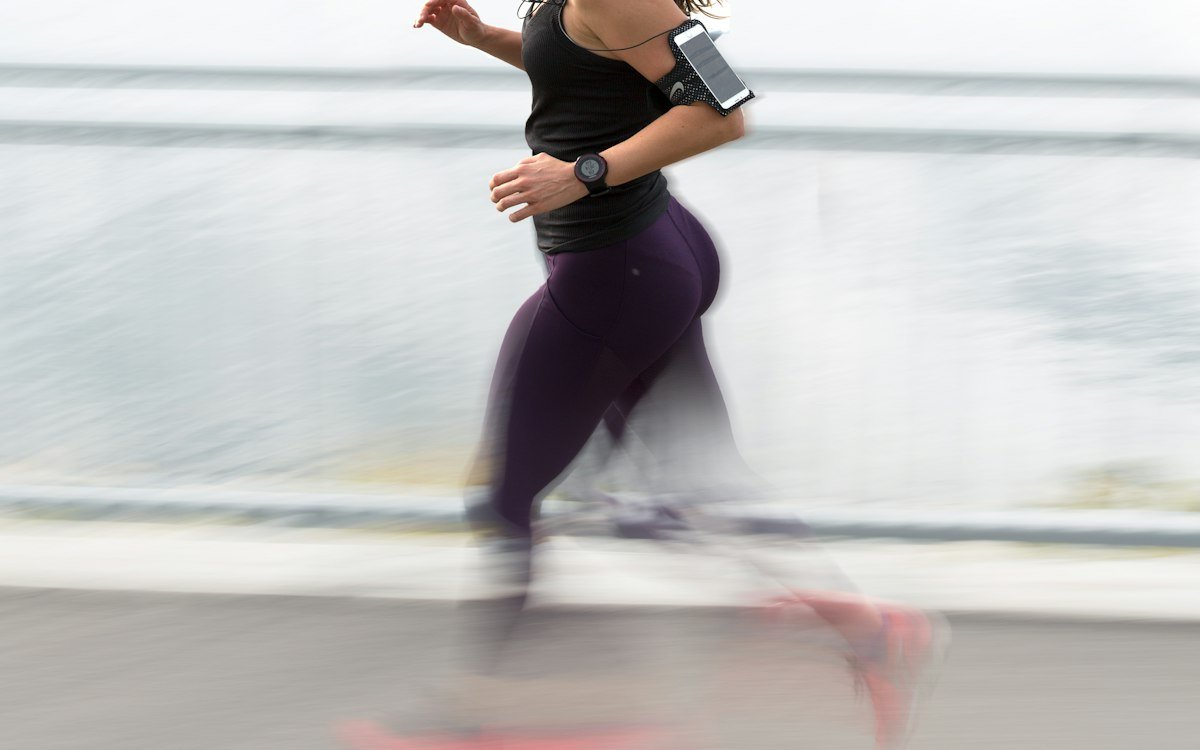 Woman running wearing armband