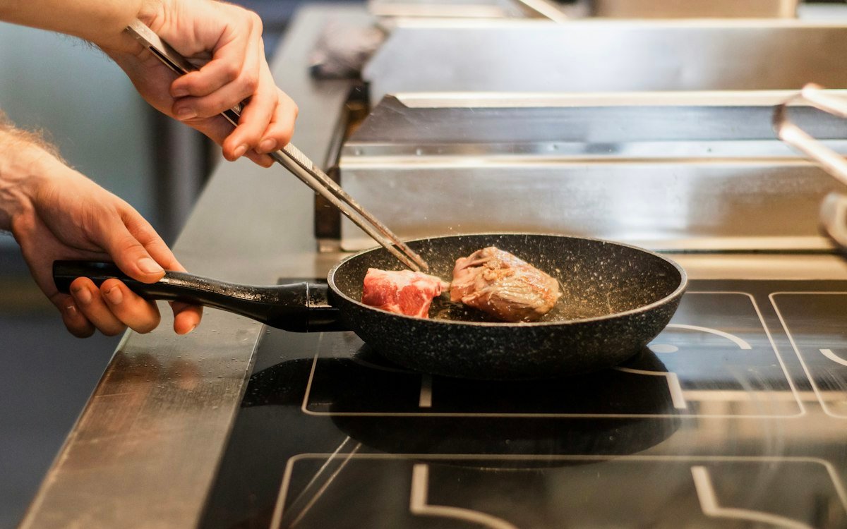 Unknown person frying meat