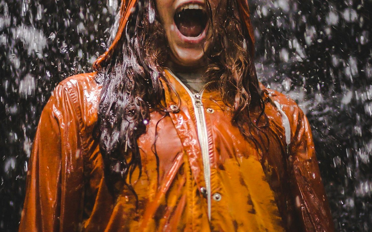 Close-up photo of woman in orange coat